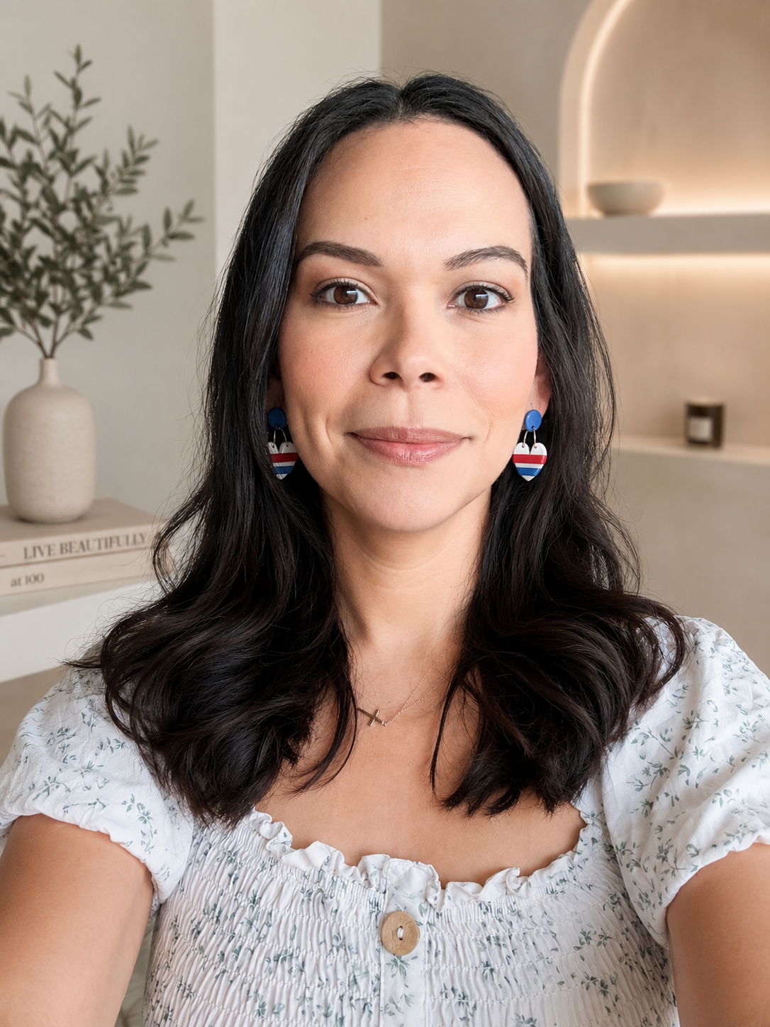 Woman wearing earrings with a neutral background