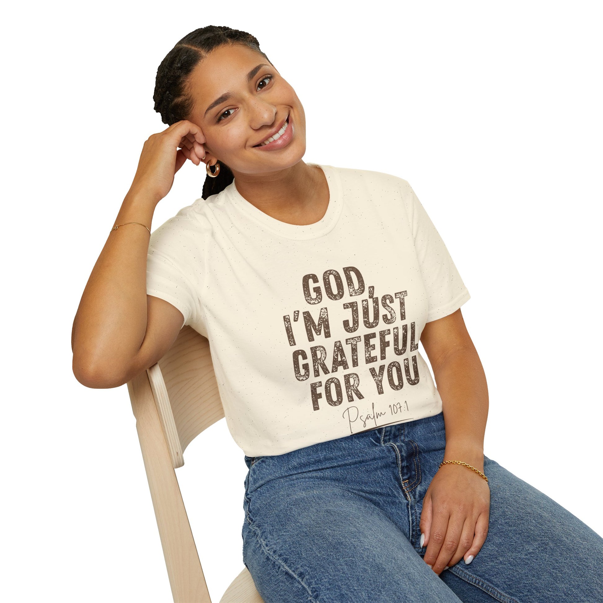 Woman wearing a white t-shirt with text sitting on a chair.
