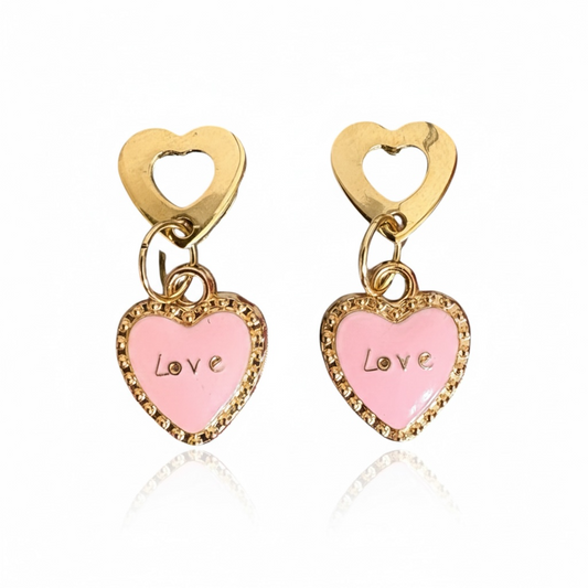 Heart-shaped earrings with pink centers and gold frames on a white background