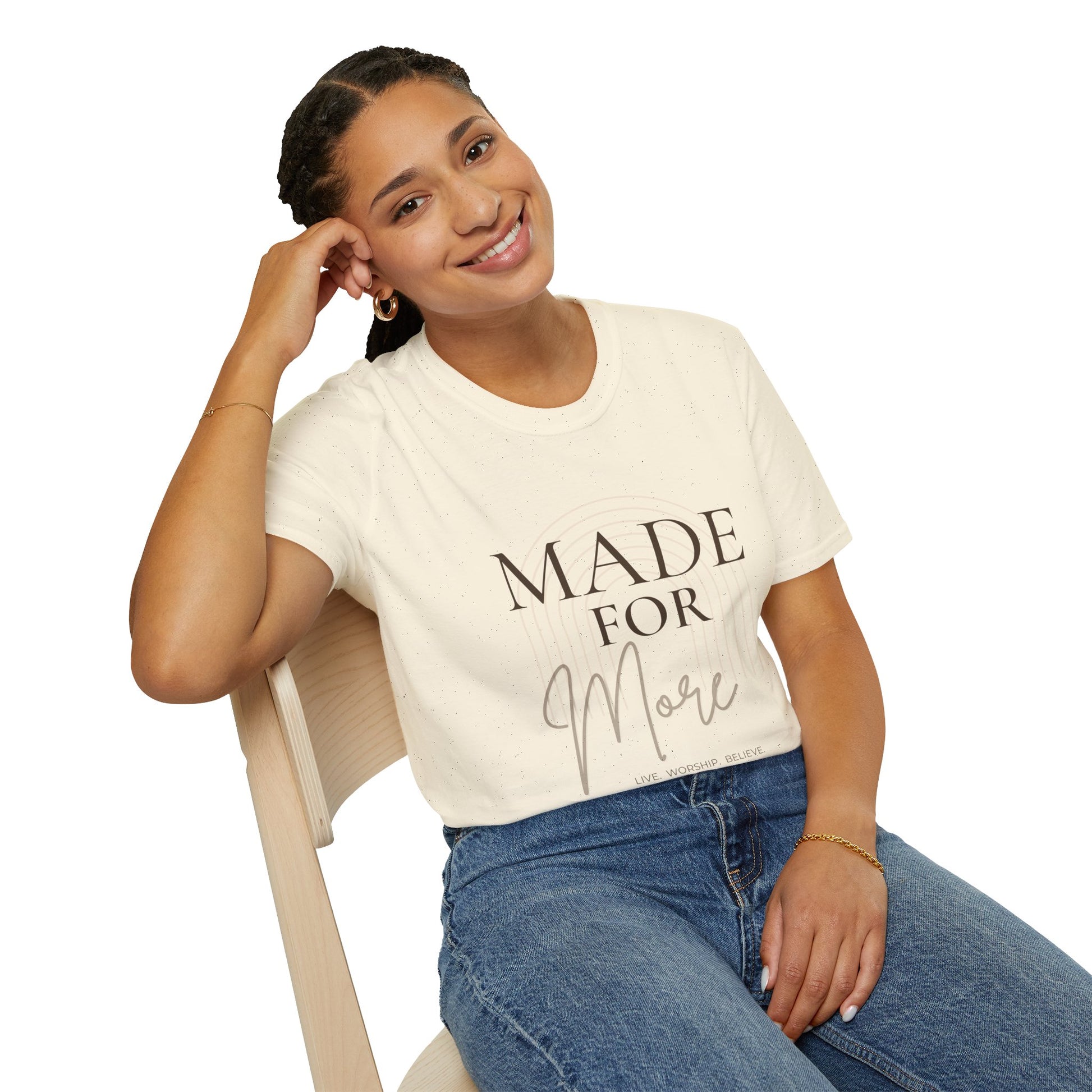Person wearing a white t-shirt with text sitting on a chair.
