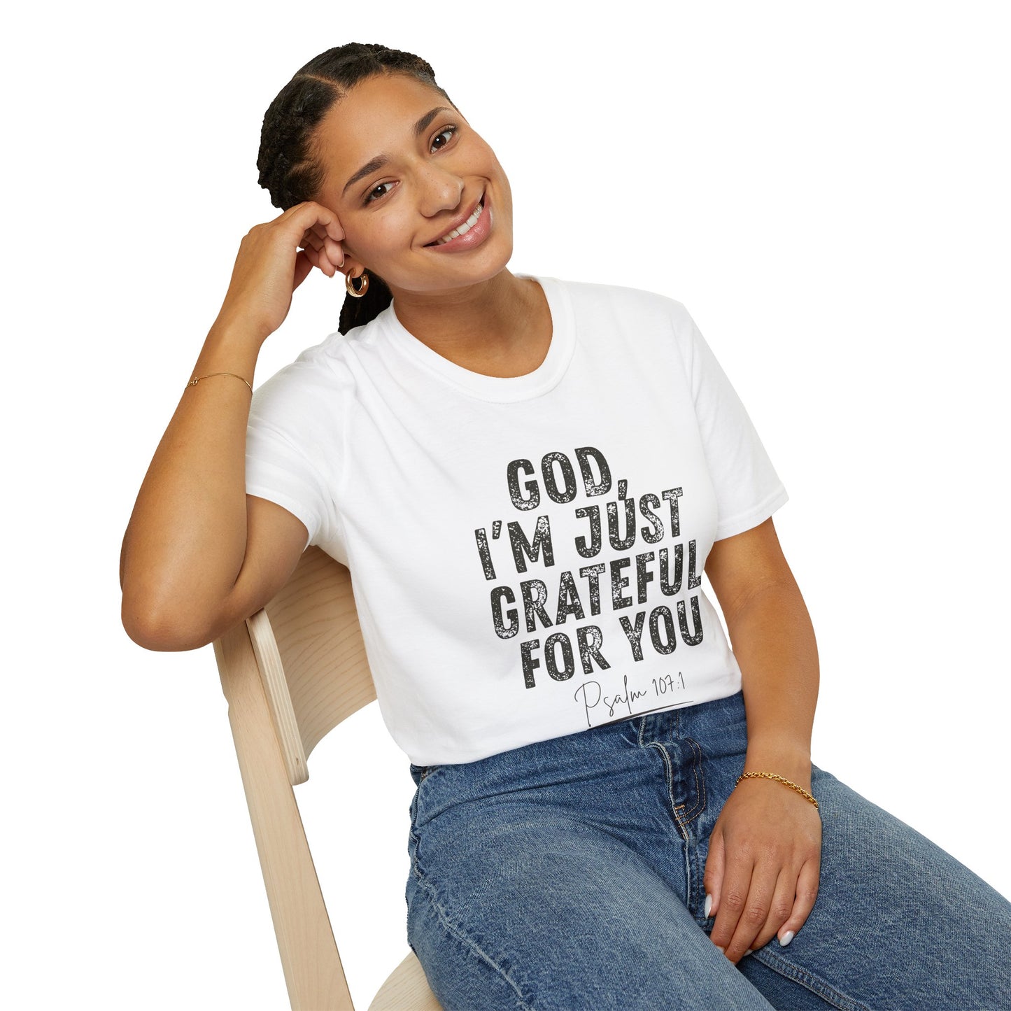 Woman wearing a white t-shirt with text sitting on a chair.