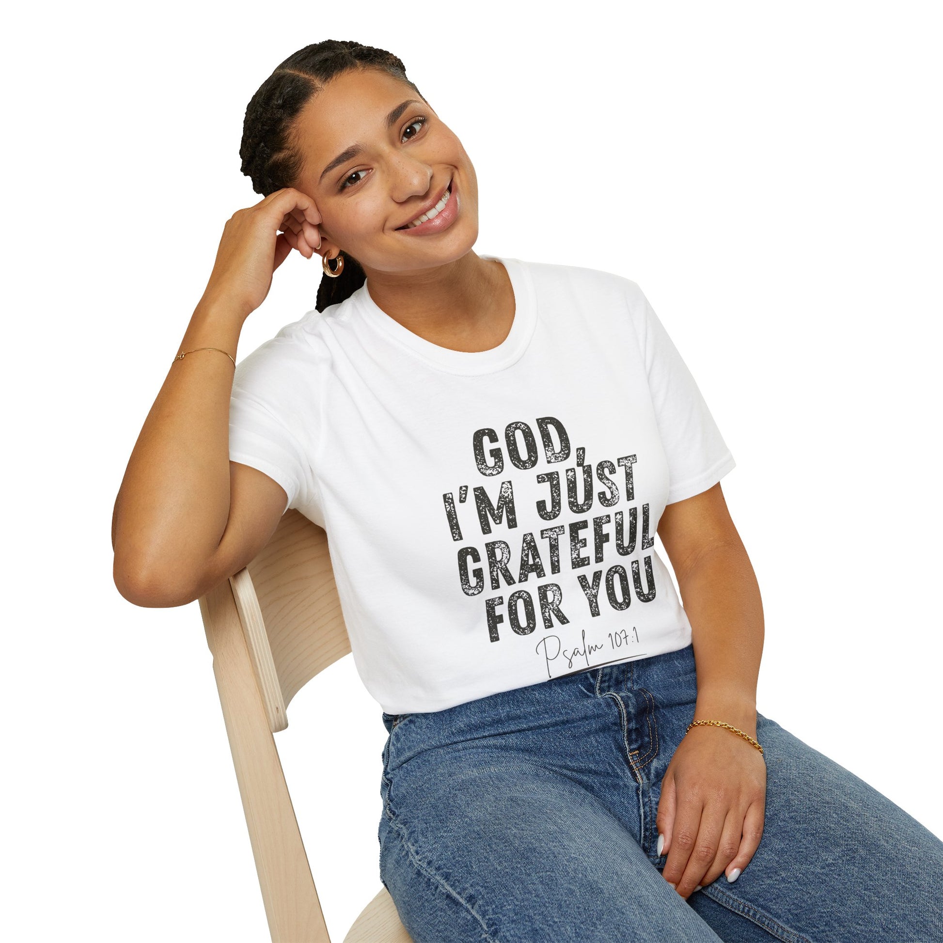 Woman wearing a white t-shirt with text sitting on a chair.