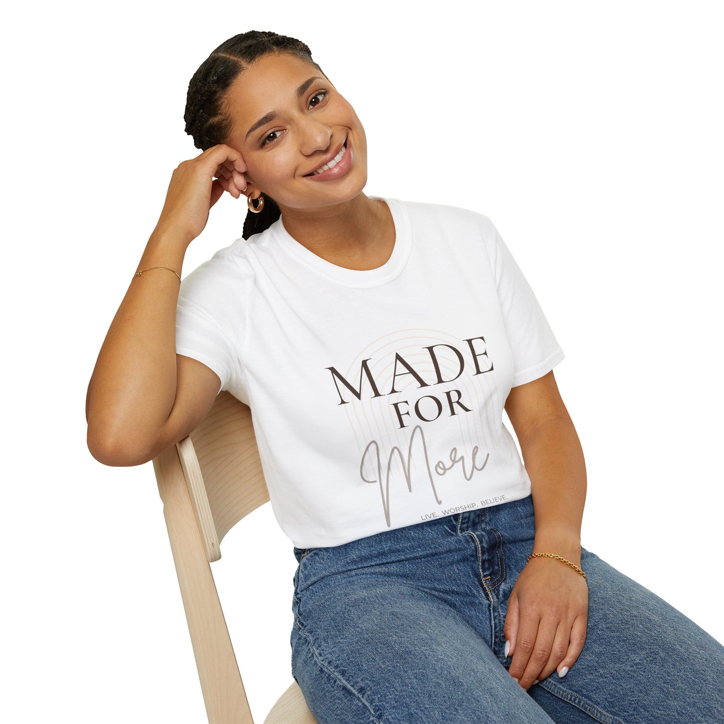 Person wearing a white t-shirt with a smiley face design, sitting on a chair.