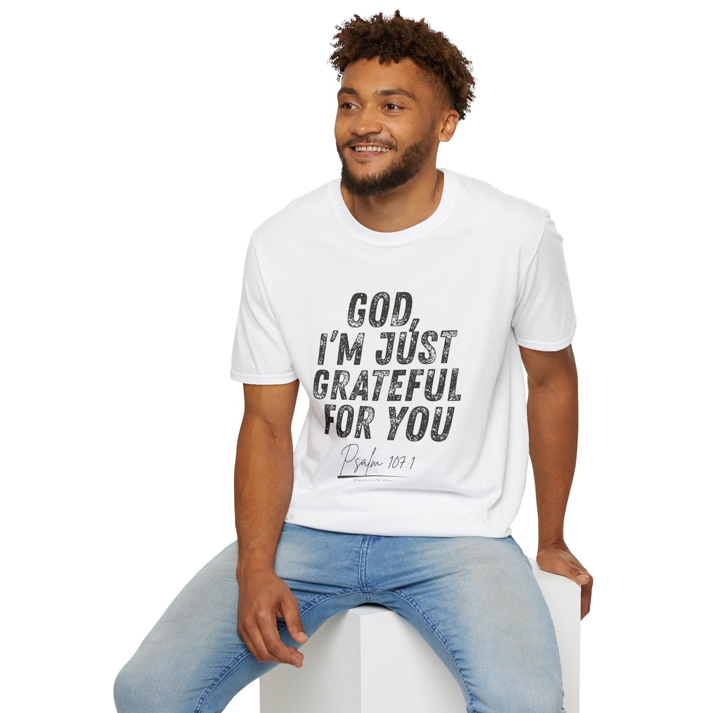 Man wearing a white t-shirt with a graphic design and text, sitting on a white stool against a white background.