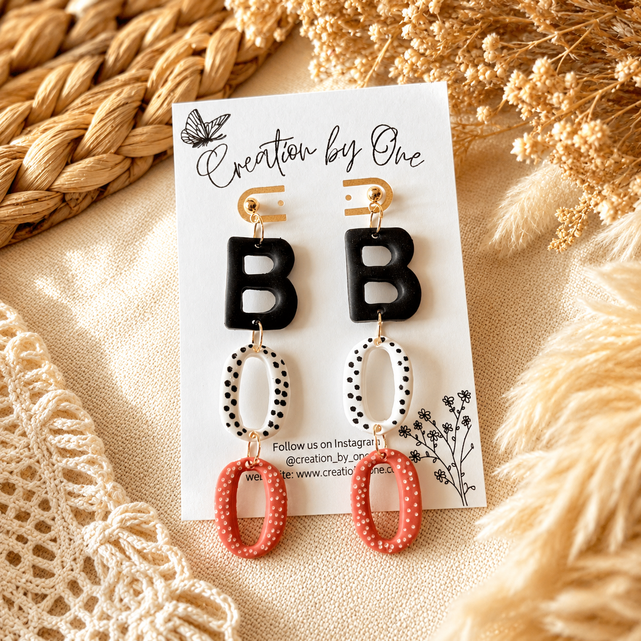Pair of earrings on a display card with decorative background