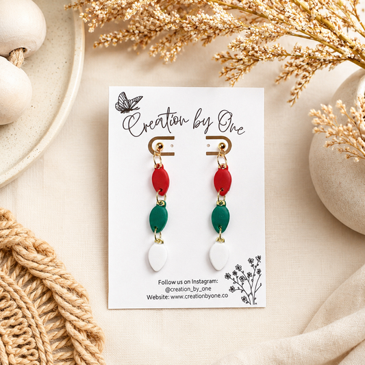 Handmade polymer clay Christmas light bulb stud earrings in red, green, and white with 14K gold-plated posts