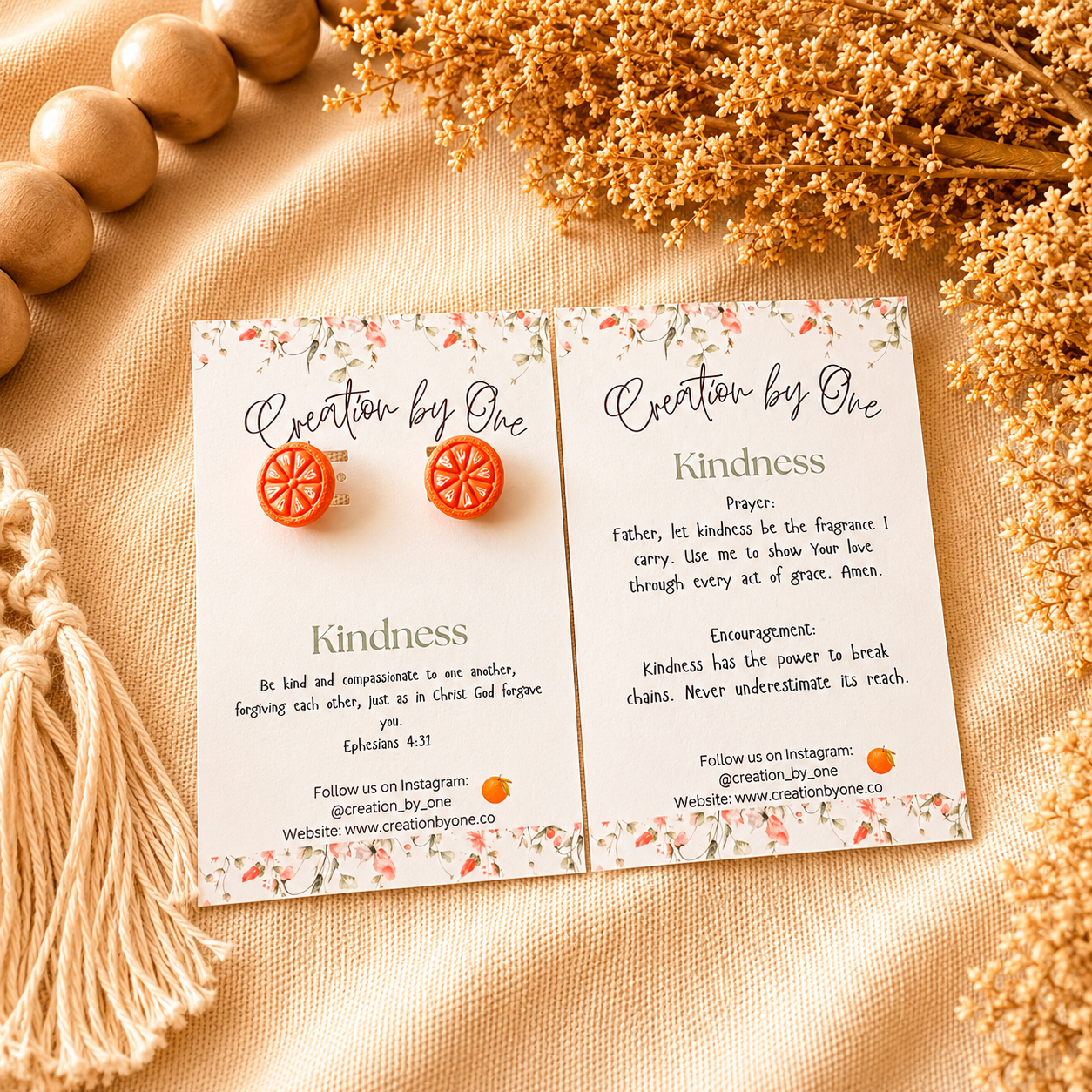 Two cards with 'Creation by One' branding on a textured surface with decorative elements.