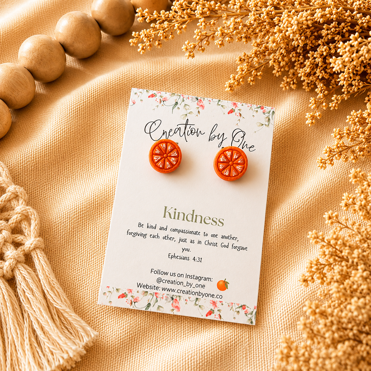 Earring card with earrings on a beige fabric background