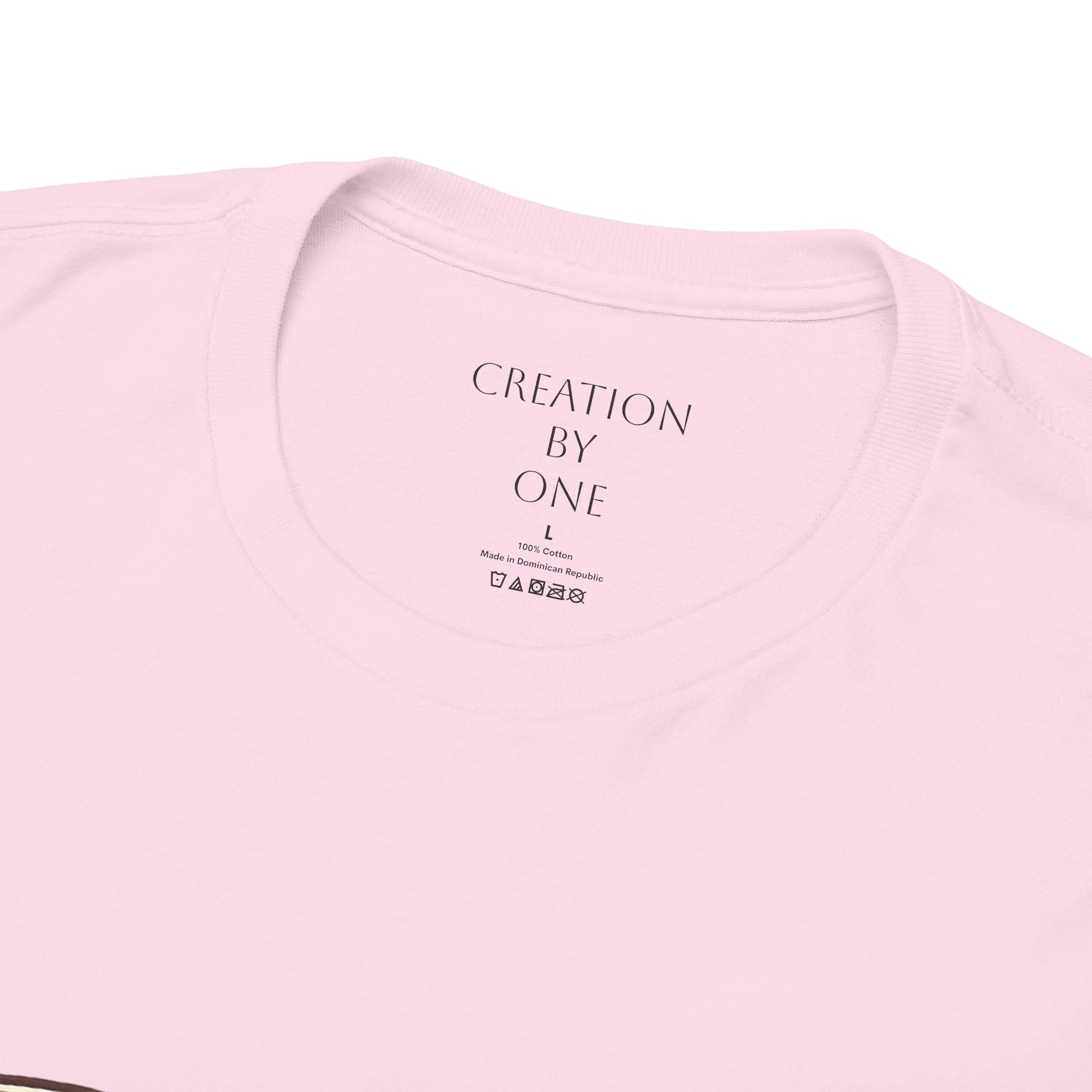 Pink t-shirt with 'Creation by One' text on a white background