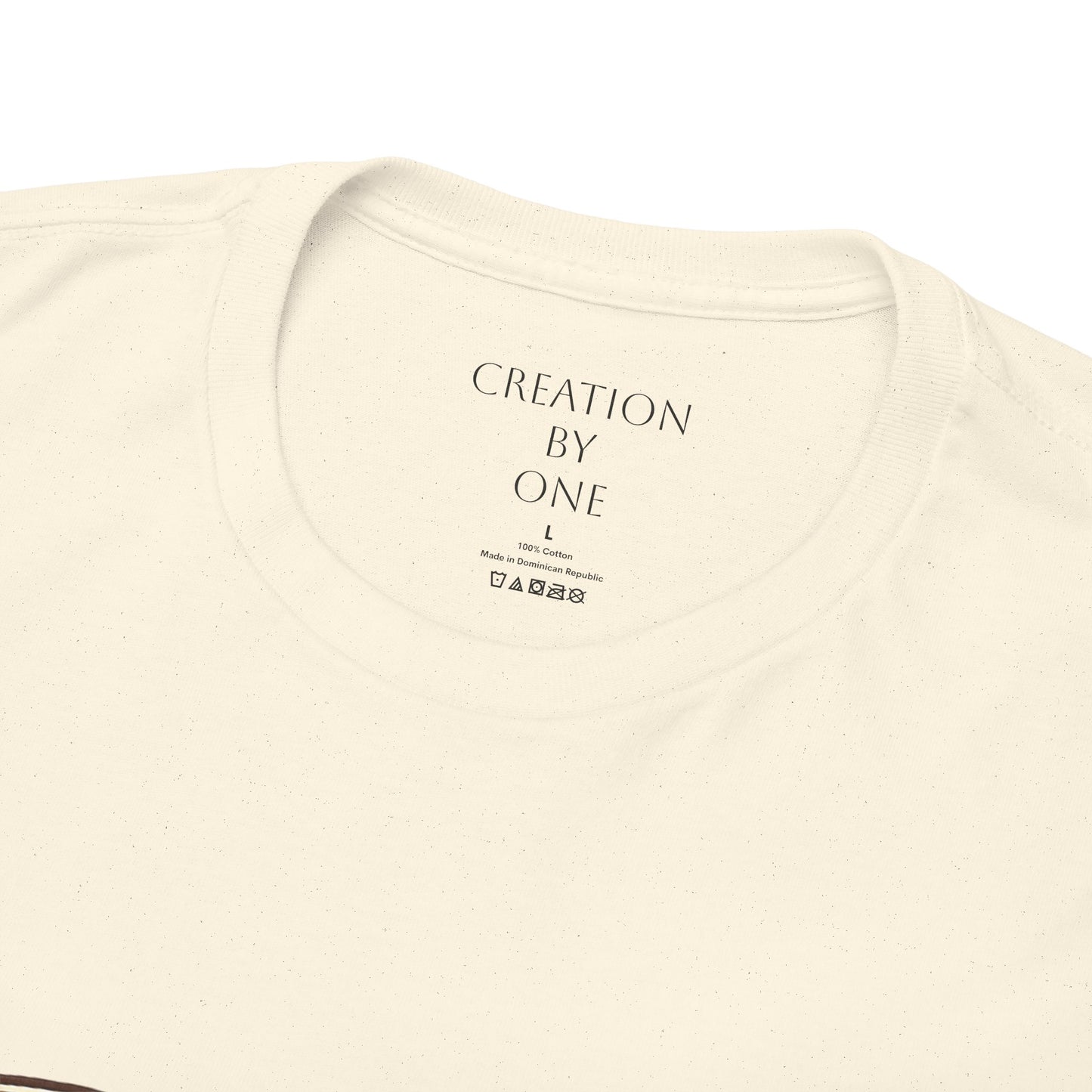Beige t-shirt with 'Creation by One' text on a white background