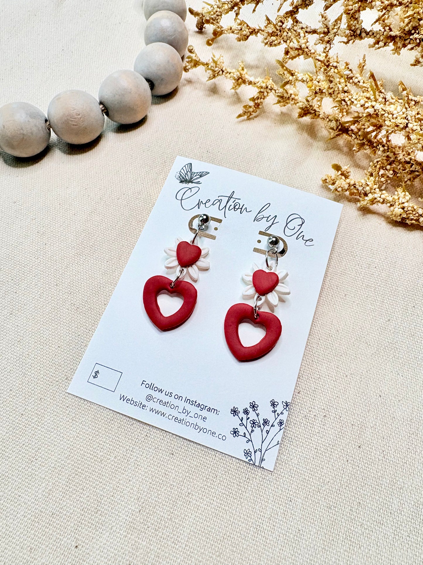 Handmade Valentine daisy earrings featuring white petals and red heart detail