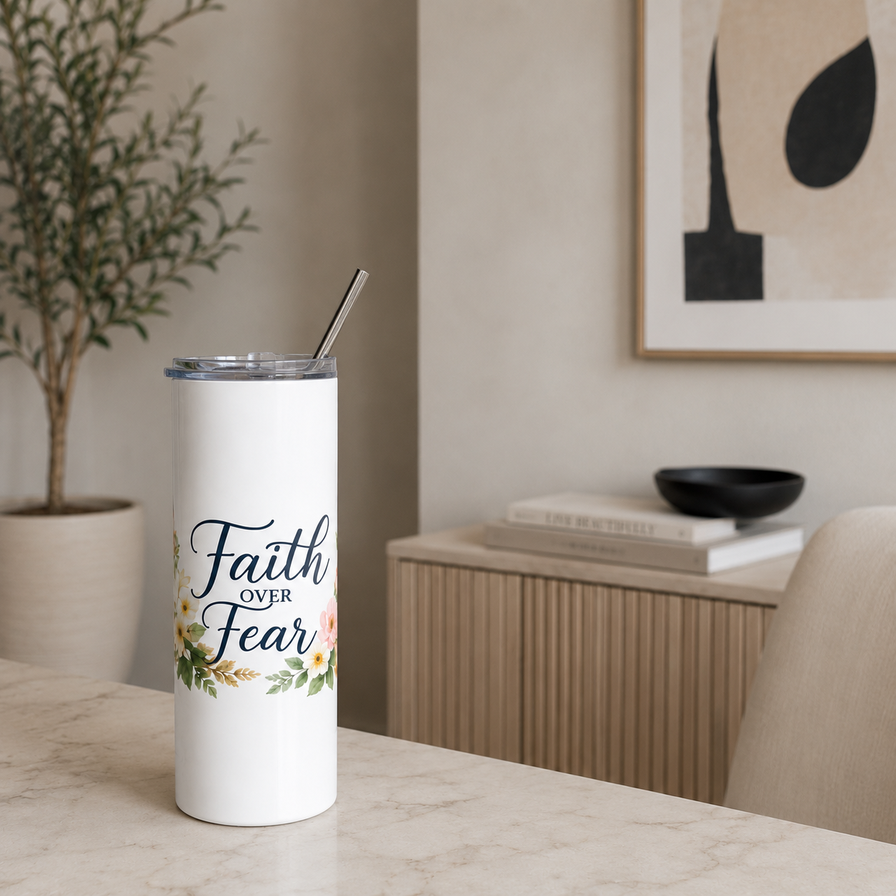 White tumbler with 'Faith Over Fear' design on a table in a home setting