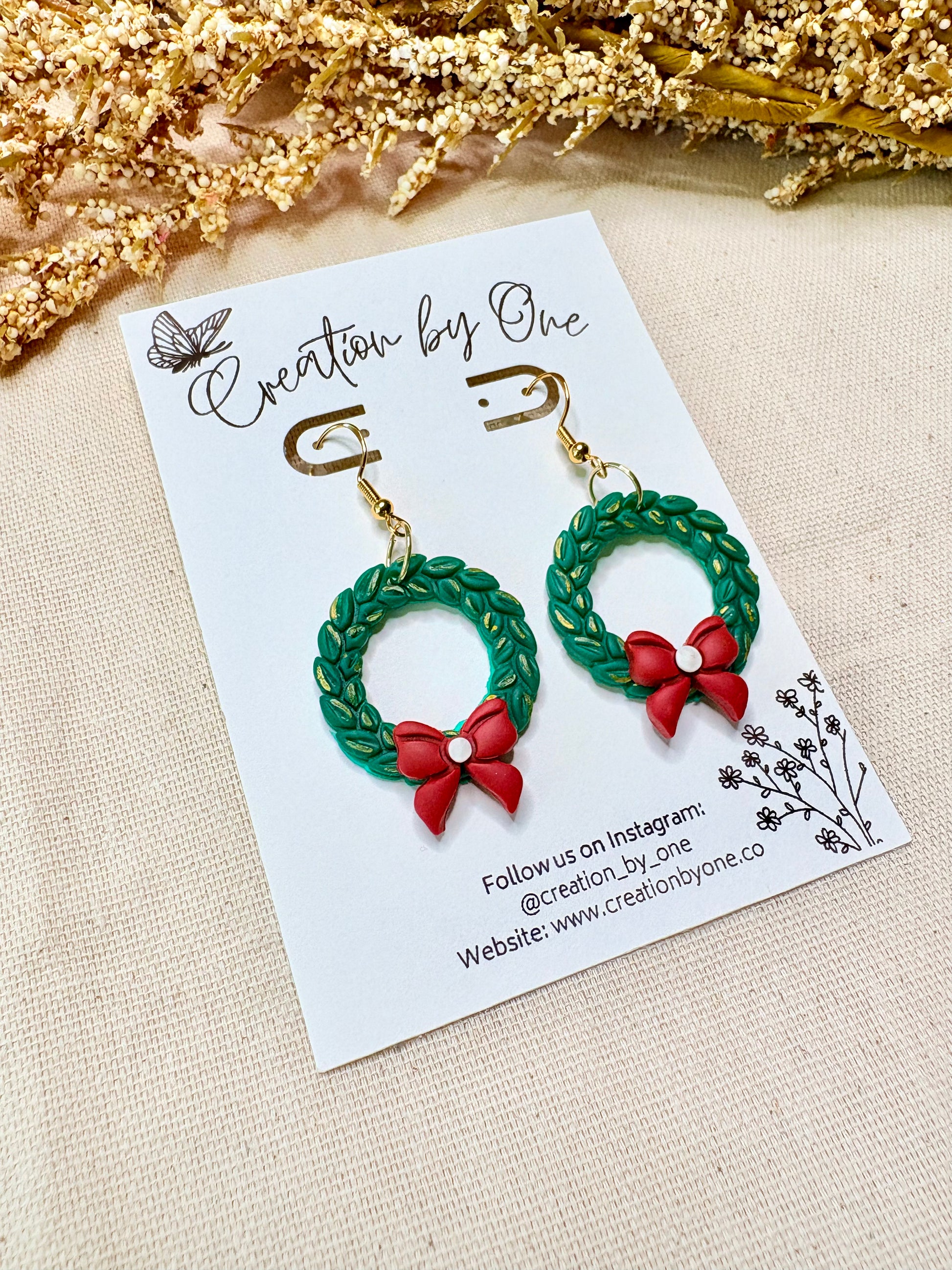 Festive polymer clay holiday wreath earrings with bow and gold-plated hooks