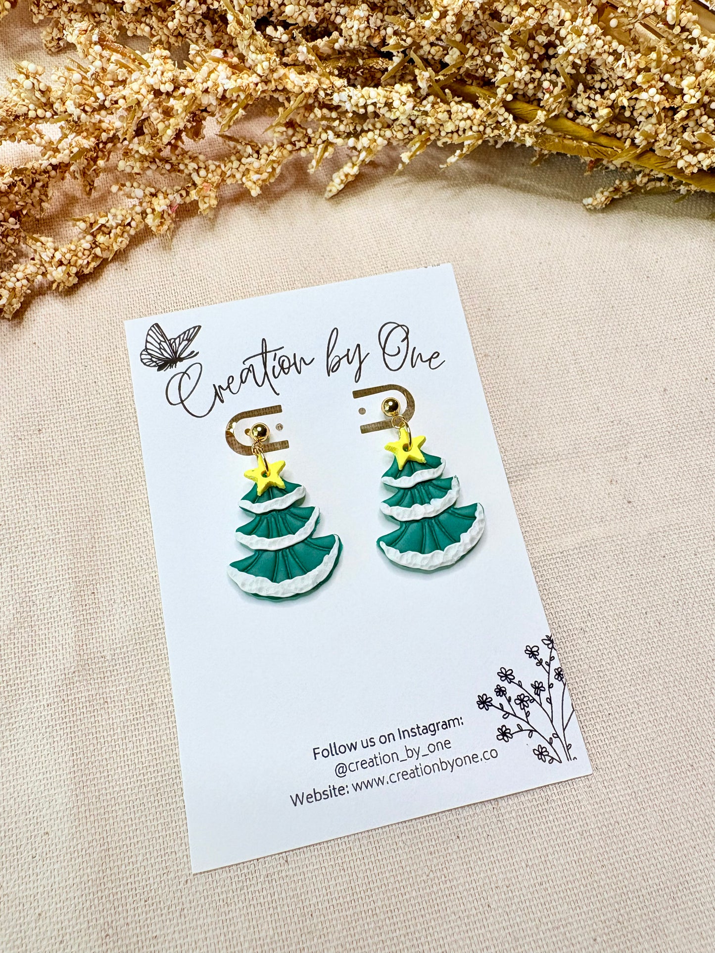 Festive snowy Christmas tree stud earrings with golden star, crafted from polymer clay