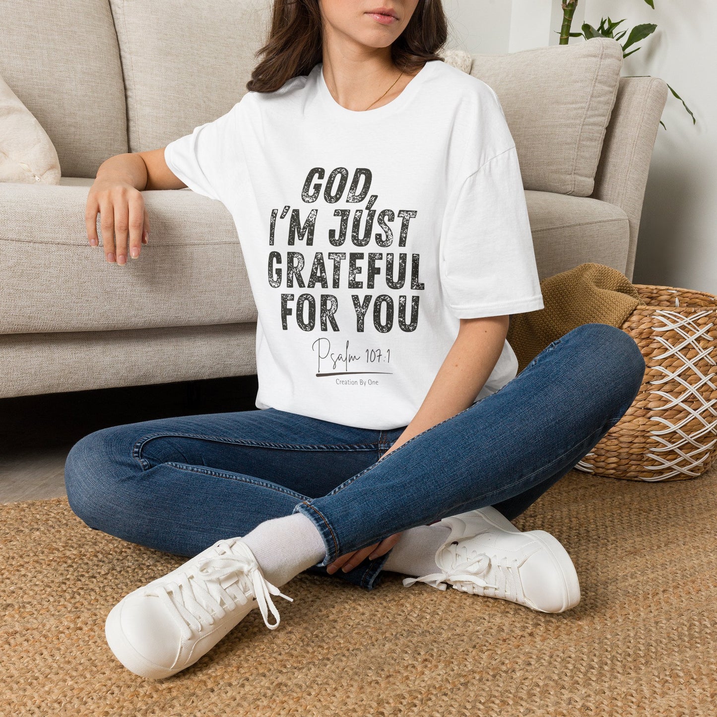 Person wearing a white t-shirt with 'Fuelled by Coffee & Coding' design, sitting on a carpeted floor.