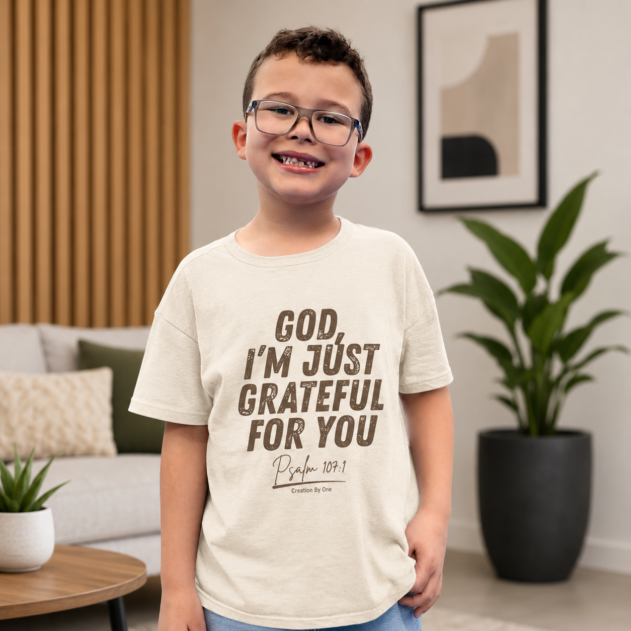 Child wearing a t-shirt with a motivational quote in a living room setting