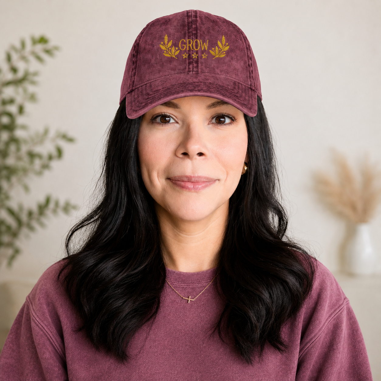 A women wearing a maroon color hat that says grow.