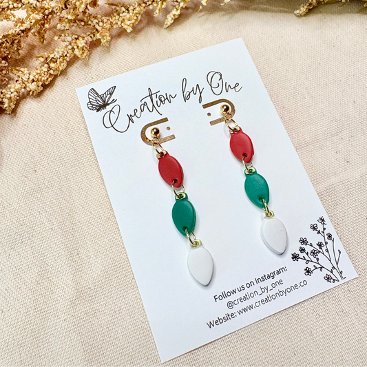 Handmade polymer clay Christmas light bulb stud earrings in red, green, and white with 14K gold-plated posts