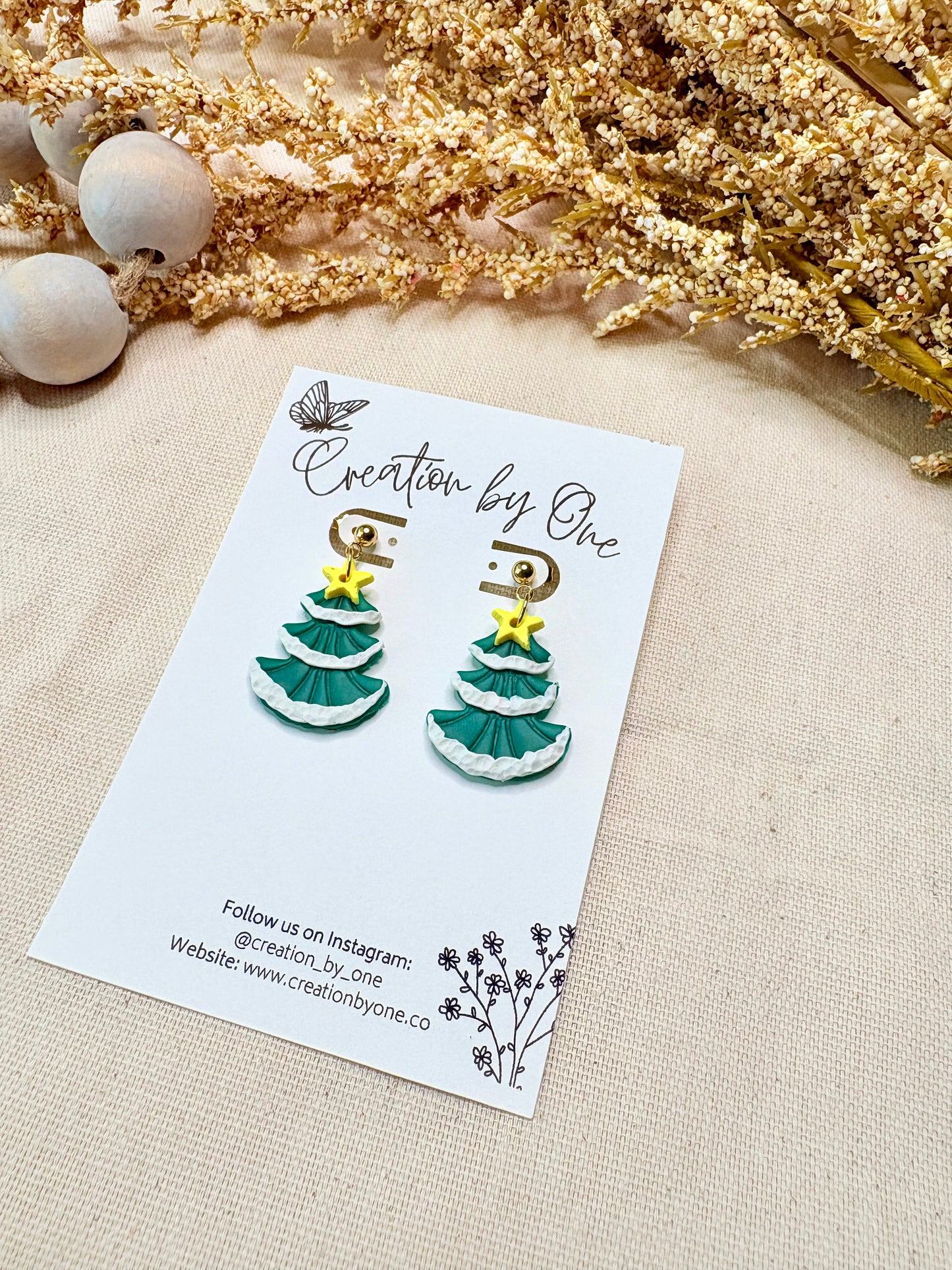 Holiday polymer clay Christmas tree earrings with snow details on 14K gold-plated hardware