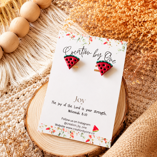 Watermelon slice earrings on a 'Creation by One' branded card with decorative elements.