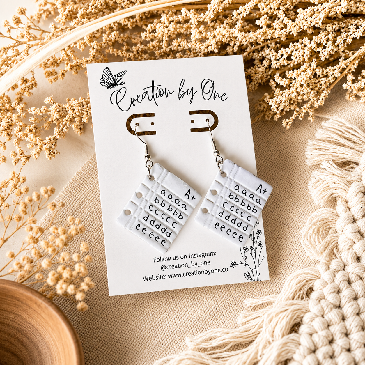 Pair of earrings on a card with decorative elements