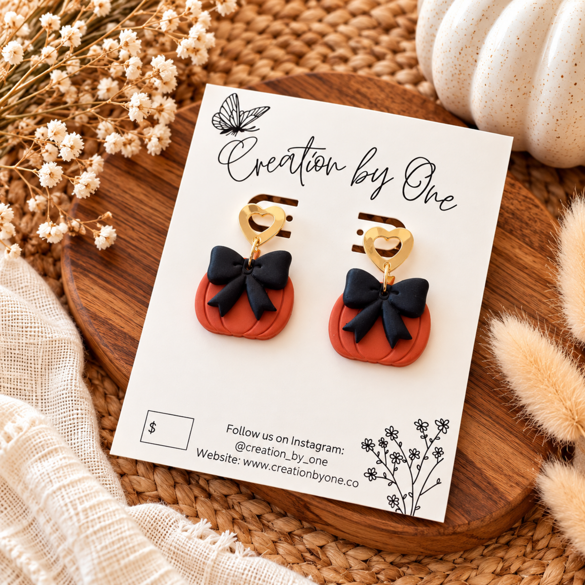 Handmade orange pumpkin earrings with black bows and gold heart studs
