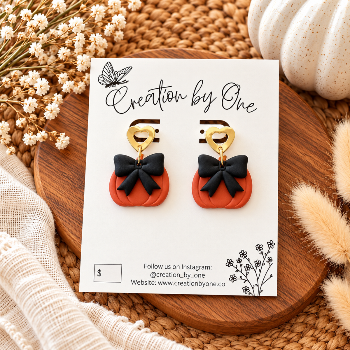 Handmade orange pumpkin earrings with black bows and gold heart studs