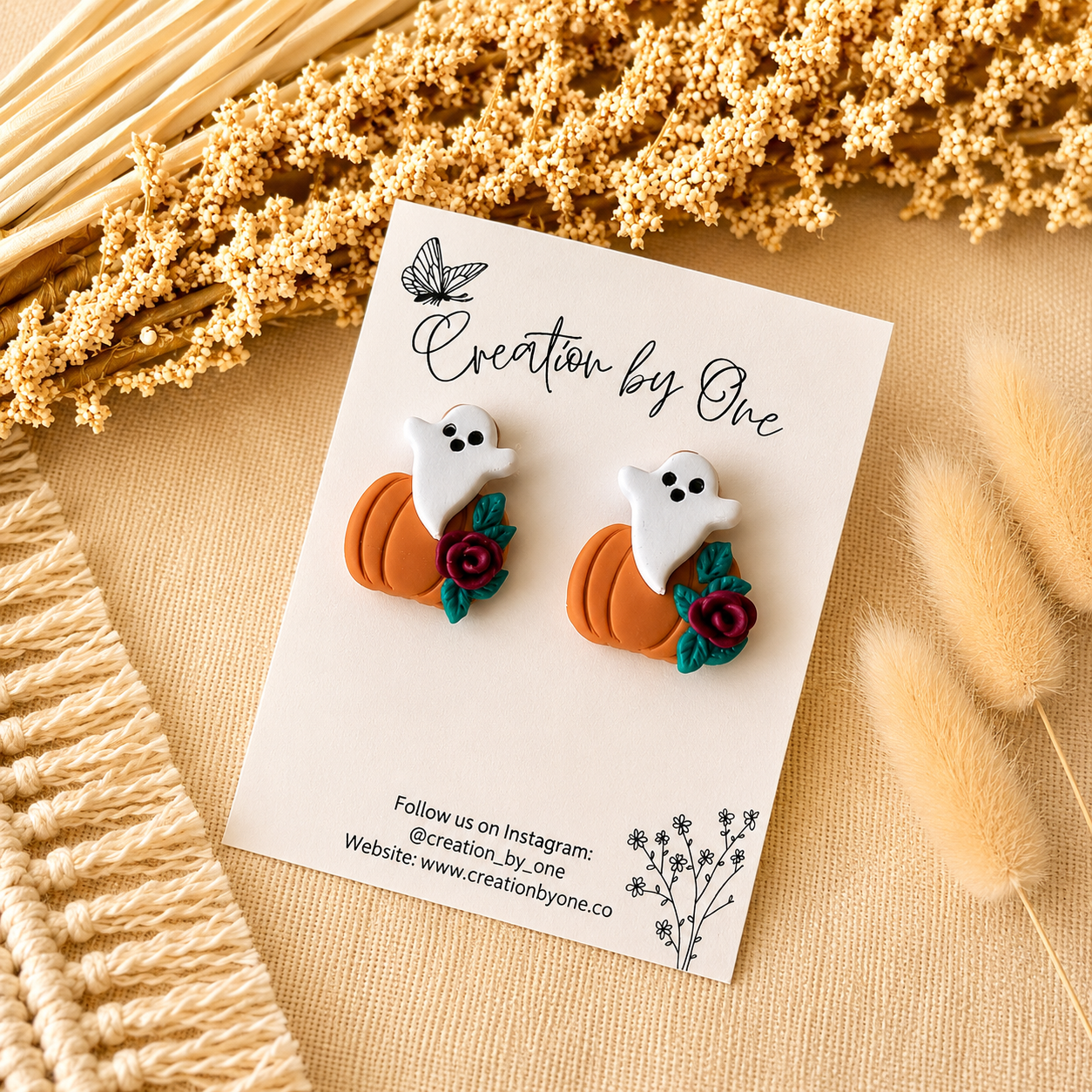 Halloween-themed earrings on a card with decorative elements