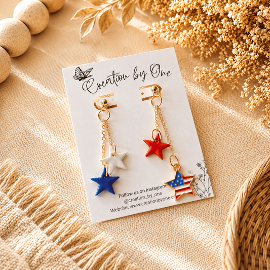 Star-shaped earrings on a branded card with decorative elements on a beige surface