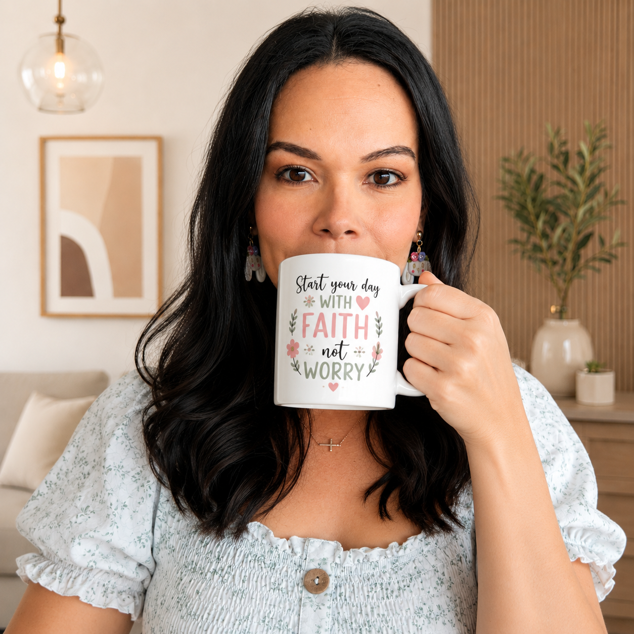 Woman holding a mug with motivational quote in a home setting