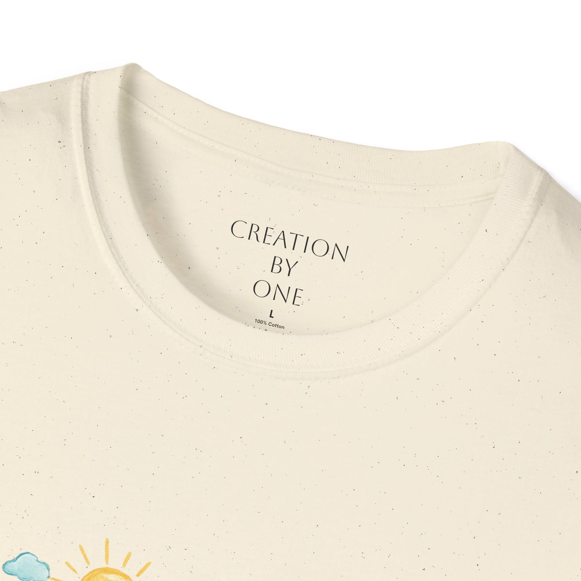 Close-up of a beige t-shirt with 'Creation by One' text on a white background