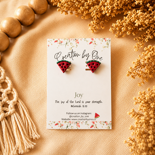 Watermelon slice earrings on a card with decorative elements on a beige background